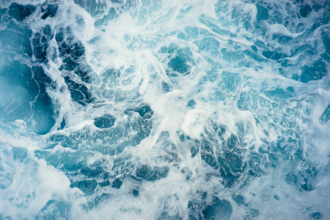Blue ocean water with white froth