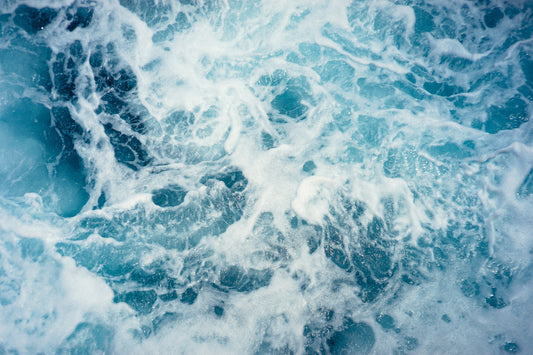 Blue ocean water with white froth
